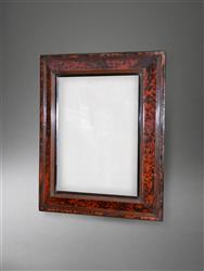 An 18th century tortoiseshell frame mirror.