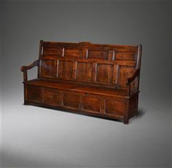 An early 18th century oak box seated settle.