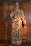A large polychromed figure of an evangelist.