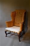 An early 18th century walnut leg wing chair.