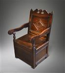 A Charles II oak box seated armchair.