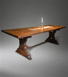A mid 18th century oak and ash trestle table.