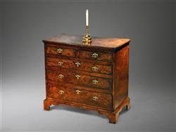 A small George I burr oak chest of drawers.