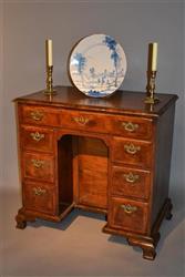 A George II walnut veneered kneehole desk.
