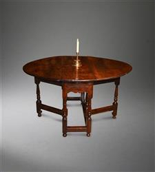An early 18th century yew wood gateleg table.