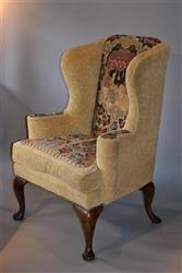 An elegant George I walnut leg wing chair. 