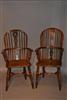 A matched set of eight yew wood Windsor armchairs.