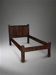 A 17th century oak half tester bed.