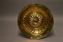 A large late 16th century brass alms dish.