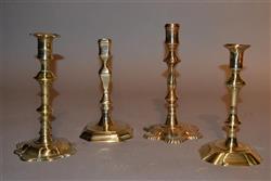 Four 18th century brass candlesticks.