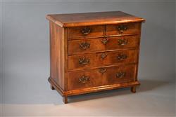 A Queen Anne walnut chest of drawers.