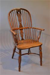 An early 19th century yew wood Windsor armchair.