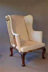 A George II walnut wing back armchair.
