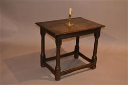 A Charles II oak centre table.