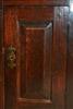 A tiny Welsh George II oak corner cupboard.