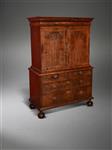 A Queen Anne walnut enclosed cabinet on chest.