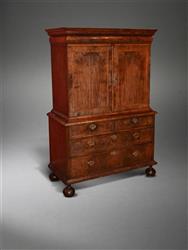 A Queen Anne walnut enclosed cabinet on chest.