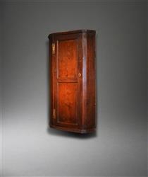 A George III oak corner cupboard.