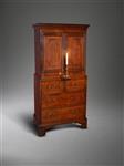 A small and unusual George III oak cupboard.