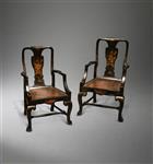 A pair of George II black lacquer armchairs.
