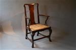 An unusual George II walnut armchair.