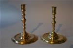 An unusual pair of early brass candlesticks.