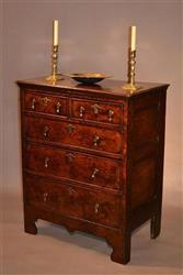 An early 18th century burr walnut and oak chest.