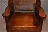 A George III oak hooded wing chair.