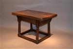 An early 18th century elm low table. 