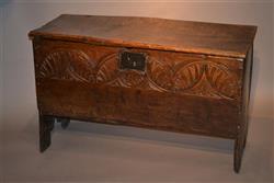 A small mid 17th century oak boarded chest.