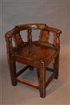 A George III elm child's corner chair in elm.