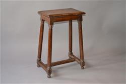 A 16th century walnut high stool. 