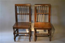 A rare pair of mid 17th century oak backstools.