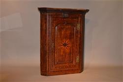 An unusual George III oak corner cupboard.