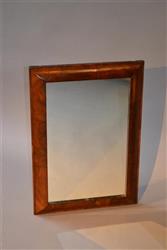 An early 18th century walnut cushion frame mirror.