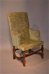 An early 18th century upholstered armchair.