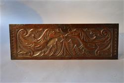 A Charles II oak coffer front depicting dragons.