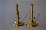 A pair of George II brass ejector candlesticks.
