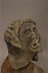 A medieval stone grotesque head of a man.