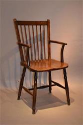 An early 19th century burr elm seat armchair.