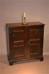 A very small Queen Anne oak cupboard.
