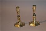 A pair of early 18th century brass candlesticks.